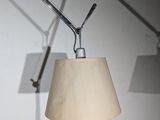 a lamp that is on the wall next to a lamp
