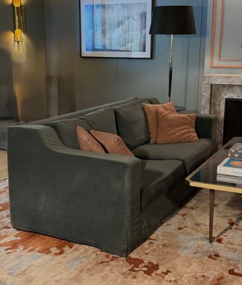 a living room with a couch, coffee table and a fireplace