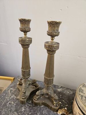 two candles that are sitting on a marble table