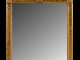 an ornately carved mirror with a bird and flower decoration
