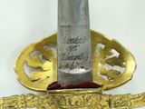 a gold plate with a knife on it and a gold plate with a knife on it