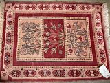 a close up of a rug on a floor with a tag on it