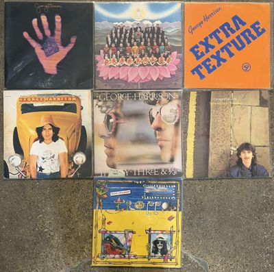 a lot of different album covers on the floor