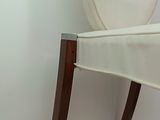 a white chair that is next to a white wall