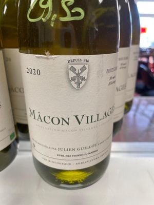 three bottles of wine are on a table in a store