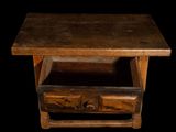 a small wooden table with a drawer underneath it