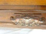 a close up of a wooden table with a drawer on it