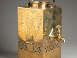 an antique brass teapot with a handle on a grey background