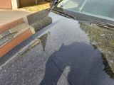 a shadow of a person on the hood of a car