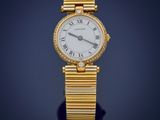a close up of a gold wrist watch with roman numerals
