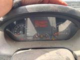 someone is holding the steering wheel of a car with a speedometer