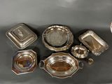 several silver plated dishes and trays on a table