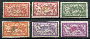 a group of six different colored postages on a black surface
