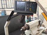 an image of a machine that is working on a piece of metal