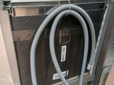a hose attached to the side of a refrigerator