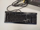 a computer keyboard and mouse on a desk next to a laptop