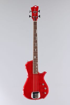 an electric bass guitar with a red body on a white background