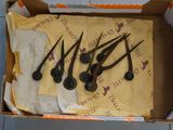 five spoons in a box on a tile floor
