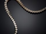 a close up of a necklace with a chain attached to it