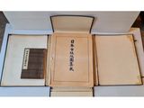 two boxes of books with chinese writing on them sitting on a table