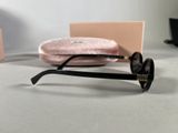 a pair of sunglasses sitting on a table next to a pink case