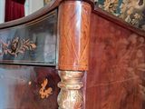 a bed that has a wooden frame with a floral design on it