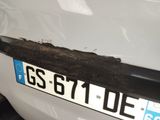 a close up of a license plate on a white car