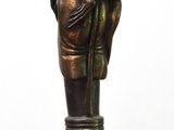 a statue of a hand holding a cane with a fist on it