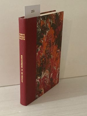 un livre à la couverture rouge posé sur une table blanche