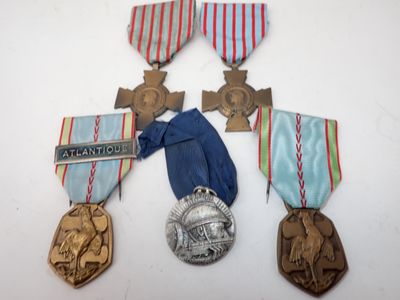 three medals and a medal on a white surface