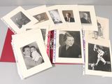 a lot of old black and white photos on a table
