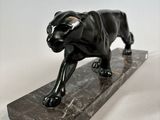 statue of a black panther on a marble base on a white background