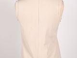 the back of a white dress with black beads on a mannequin
