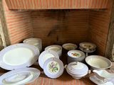 a lot of plates and bowls sitting on the floor