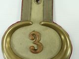 a small clock with the number 3 on it
