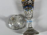 a glass cup and saucer sitting next to each other