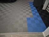 a blue and black checkered floor in a garage