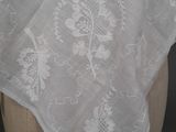 embroidered white linen shawl on a mannequin head
