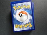 two pokemon cards sitting on top of a table next to each other