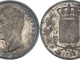 a close up of a coin with a crown on top of it