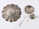 a metal object that is laying on a white surface