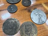 some old coins are sitting on a wooden table next to a box