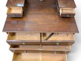 a wooden desk with drawers and a mirror on it