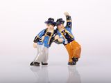 two figurines of two men standing next to each other