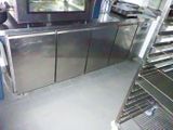 a kitchen with stainless steel cabinets and a television on top of it