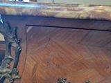 a close up of a wooden table with a clock on it