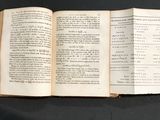 an open book that is sitting on a table
