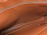 the inside of a brown leather purse with a zipper on it