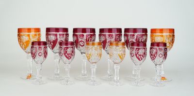 Plusieurs verres à vin sont alignés sur une surface blanche