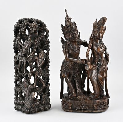 pair of bronze statues of a man and a woman on a throne